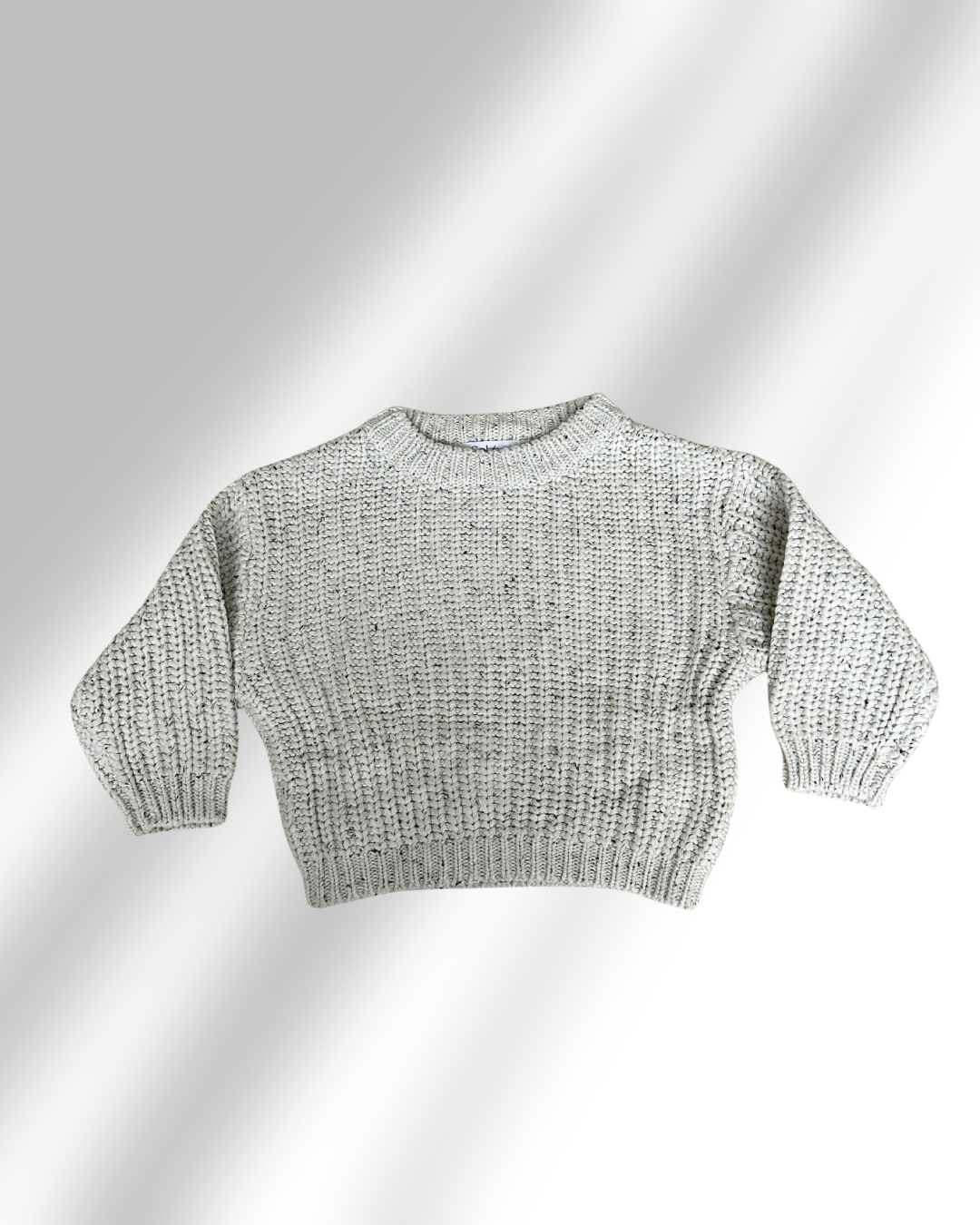beige Knitted sweater on a light gray background