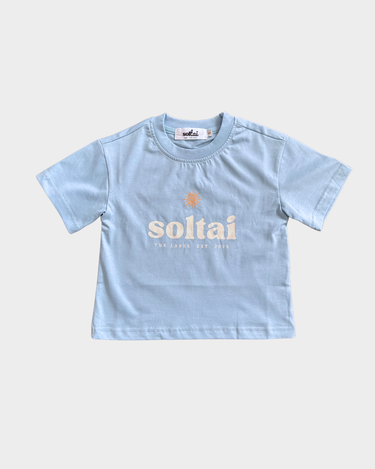 Light blue t-shirt with 'soltai' logo with a graphic orange sun on a white background