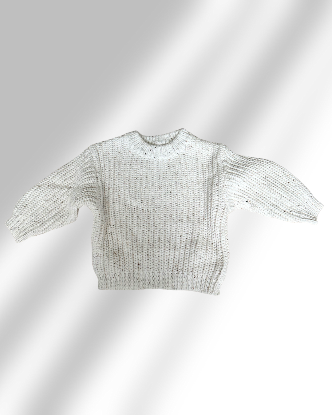 white sweater for toddlers on a gray background
